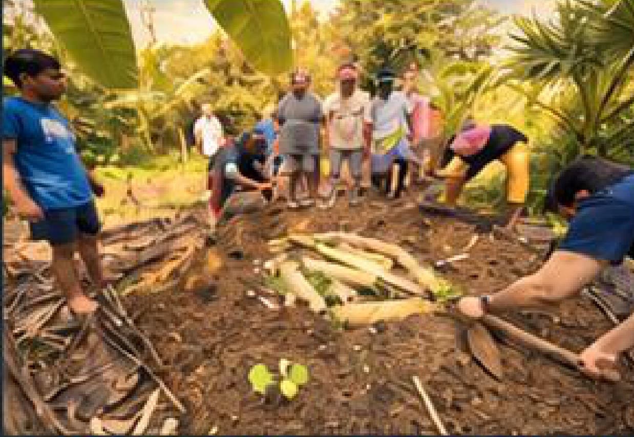 A group working the earth together at a Solitude Farm permaculture workshop.